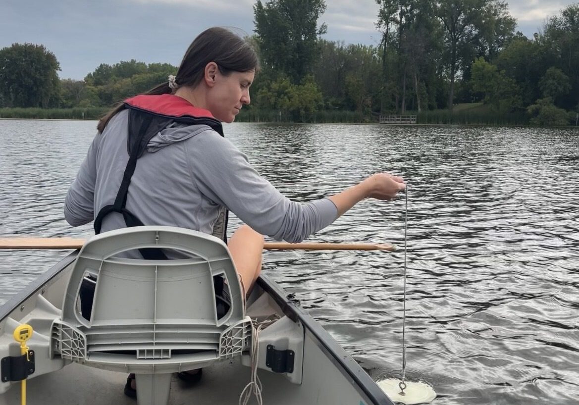 Staff dropping Secchi Desk into Shields Lake
